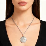 Female model wearing 316L stainless steel flower pattern photo locket necklace to showcase fit for independent online sellers
