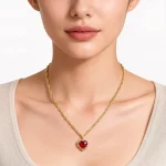 Female model wearing 18K gold plated 316L stainless steel red zircon january birthstone necklace to showcase fit for brands