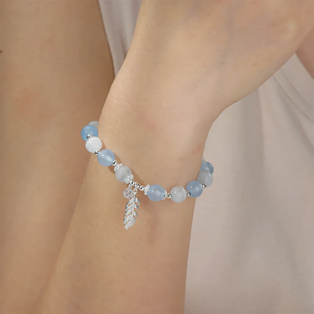 Female model wearing 316L stainless steel feather charm beads bracelet custom ODM Jewelry Manufacturer for major brands