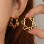Female model wearing 316L stainless steel intertwined star hoop earrings for small brands