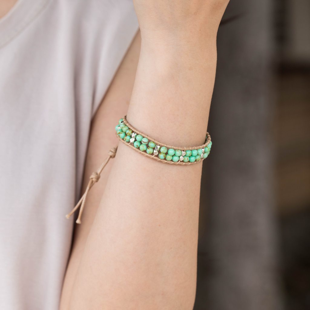 Female model wearing 316L stainless steel double layer natural stone beaded bracelet to showcase fit for small brands