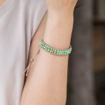 Female model wearing 316L stainless steel double layer natural stone beaded bracelet to showcase fit for small brands