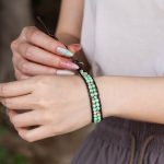 Female model wearing 316L stainless steel double layer green natural stone beaded bracelet to showcase fit for small brands