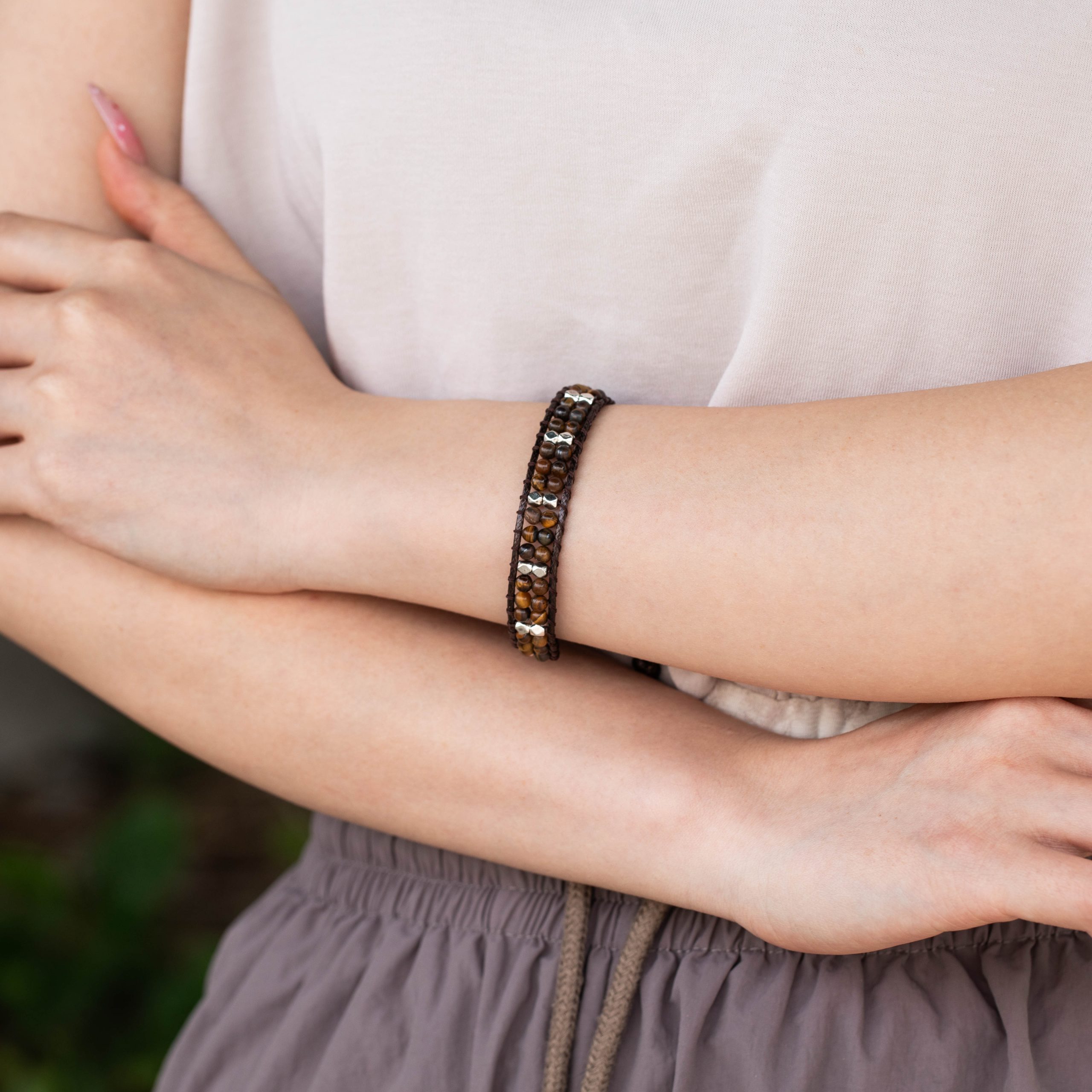 Female model wearing 316L stainless steel double-layer natural stone brown wax cord beaded bracelet to showcase fit for small brands