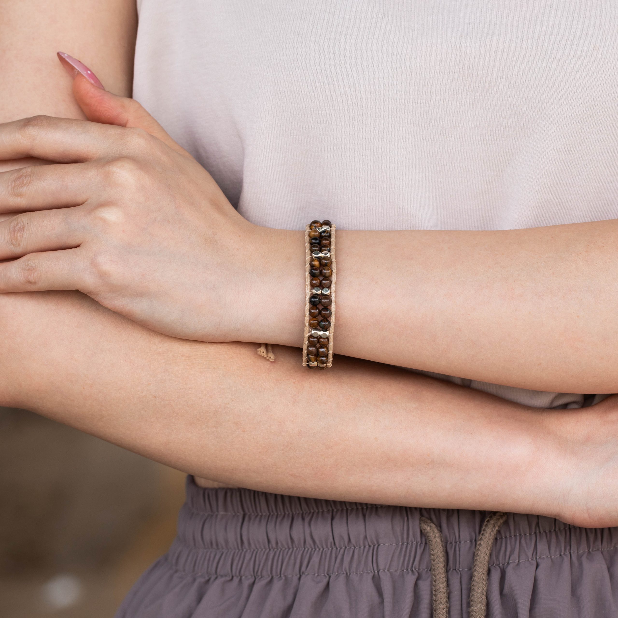 Female model wearing 316L stainless steel double layer brown natural stone beaded bracelet to showcase fit for small brands