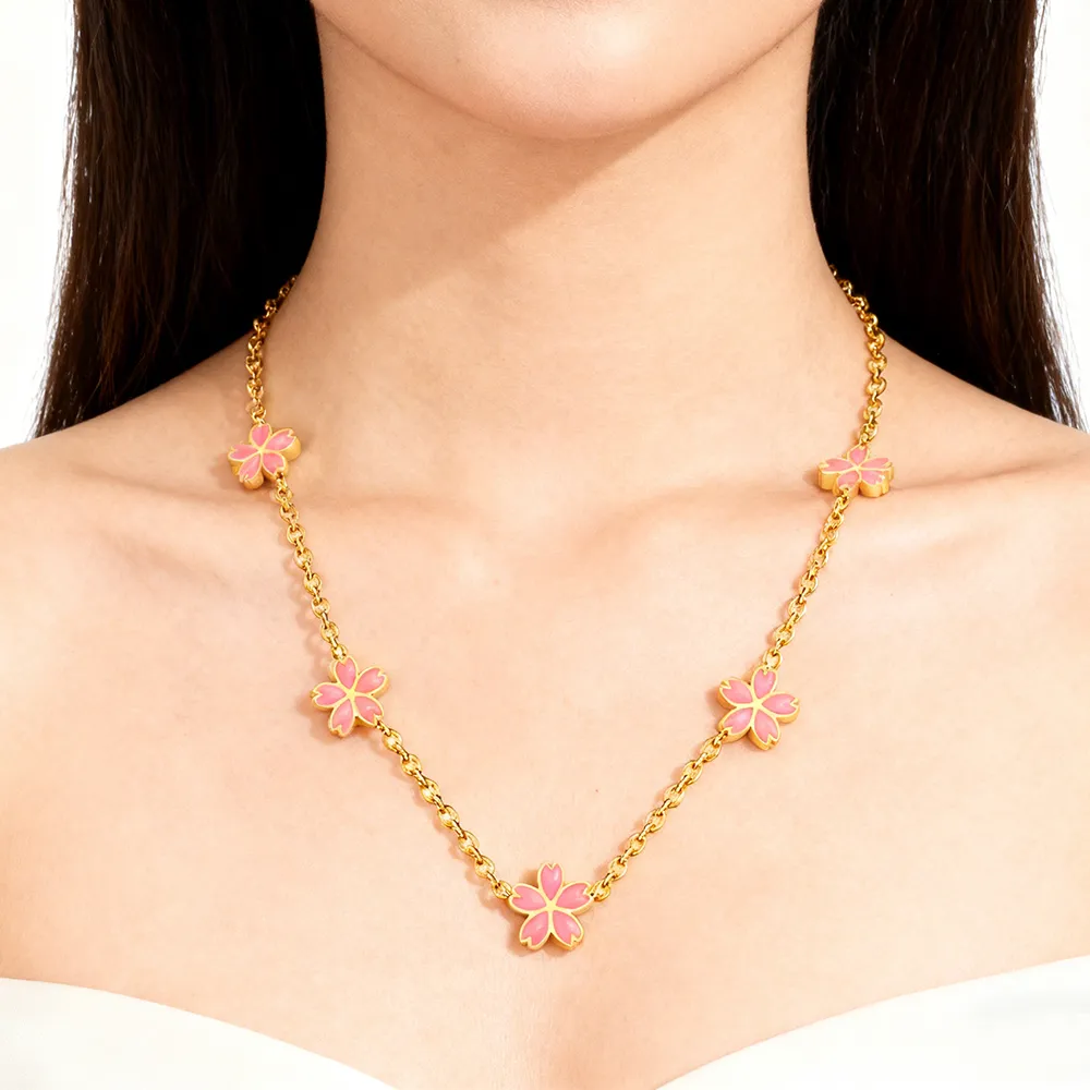 Female model wearing stainless steel sakura flower necklace from fashion jewelry supplier