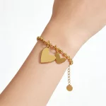 Female model wearing stainless steel bracelet to showcase length and fit for brands