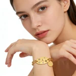 Female model wearing stainless steel charm bracelet to showcase length and fit for brands