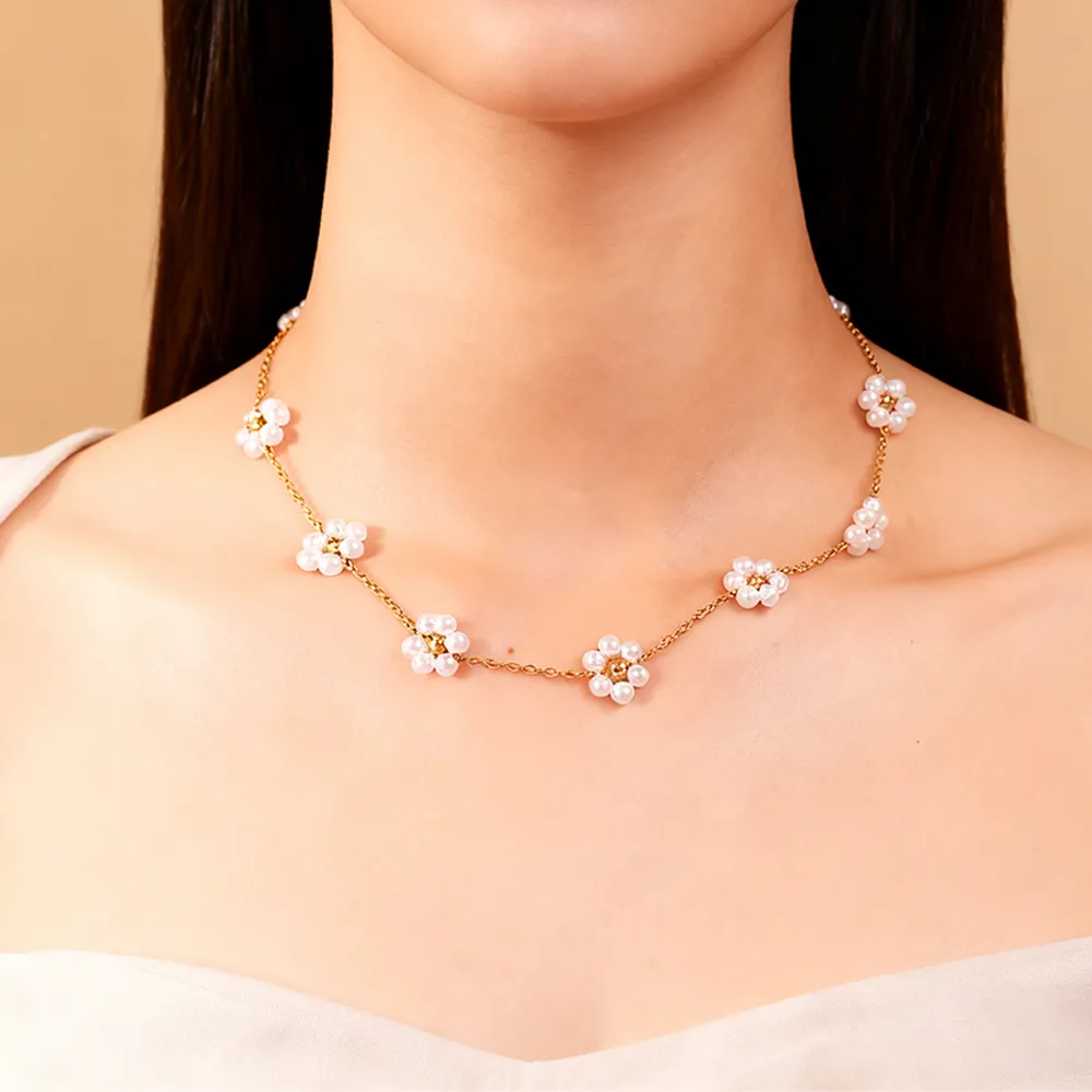 female model wearing stainless steel imitation pearl flower necklace from jewelry manufacturers