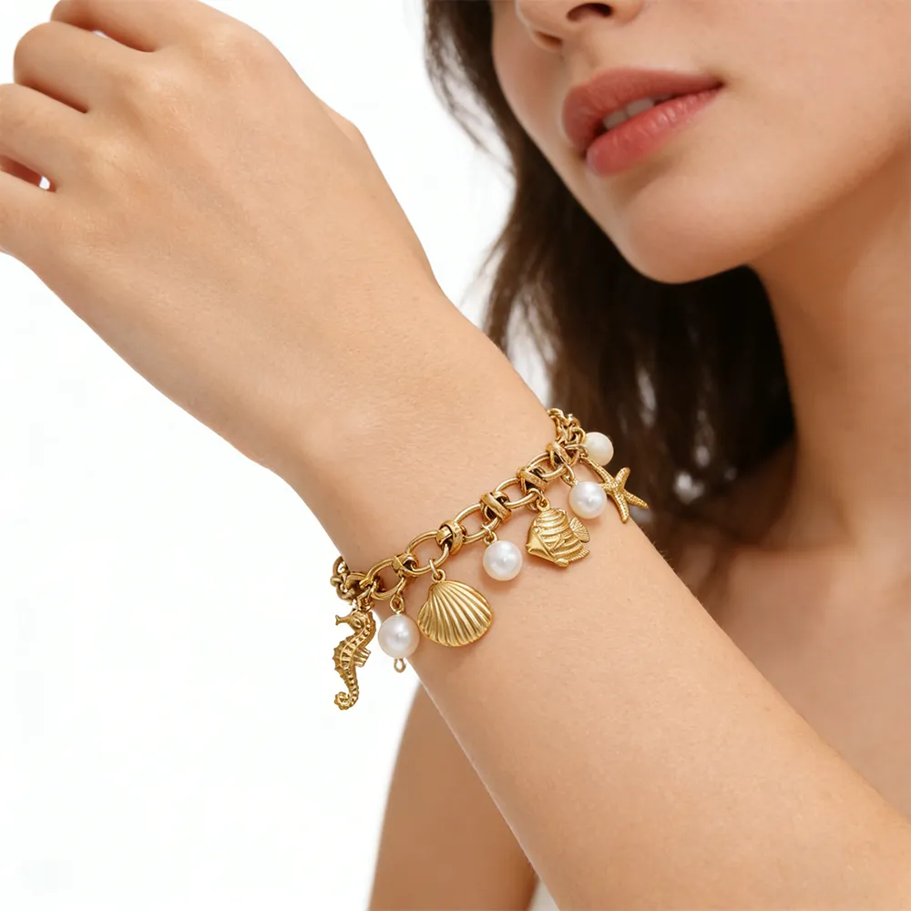 Female model wearing 316L Stainless Steel 18K Gold Plated Ocean Theme Imitation Pearl Bracelet to showcase fit for Corporate Gifting