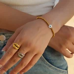 Female model wearing 316L stainless steel beaded evil eye bracelet to showcase fit for small businesses
