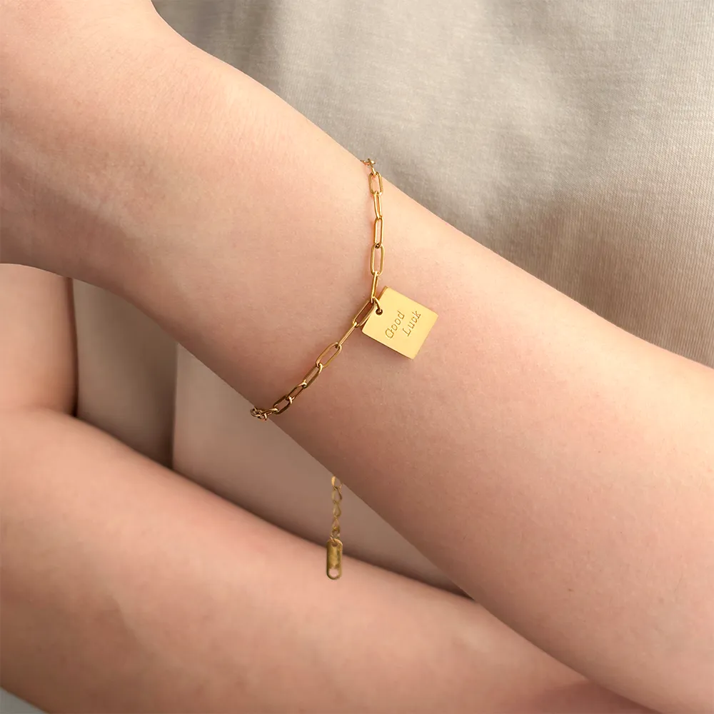 Female model wearing 316L stainless steel logo friendship bracelet to showcase fit for small brand