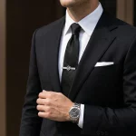 Male model wearing Silver Hollow Letter Logo Tie Clip to showcase fit for retailers