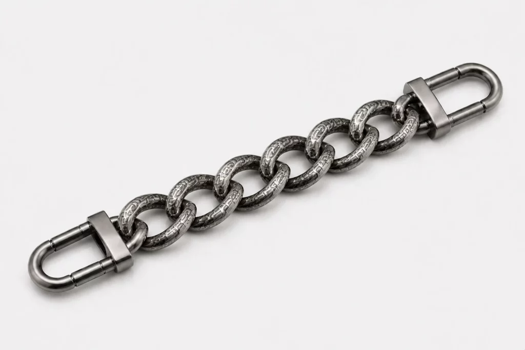 Etched metal bag chain with intricate patterns and high-precision texture, designed for B2B luxury accessory manufacturing and supply.