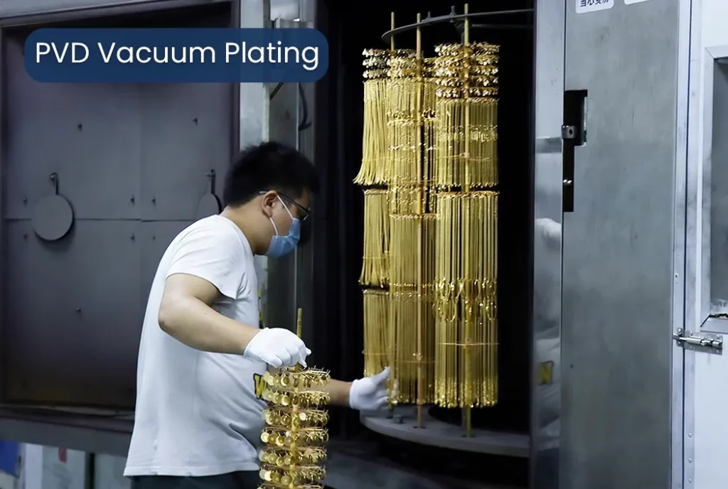 Professional PVD plating process of stainless steel jewelry in a factory, showing bracelets and rings being coated, metal finishing, industrial jewelry production