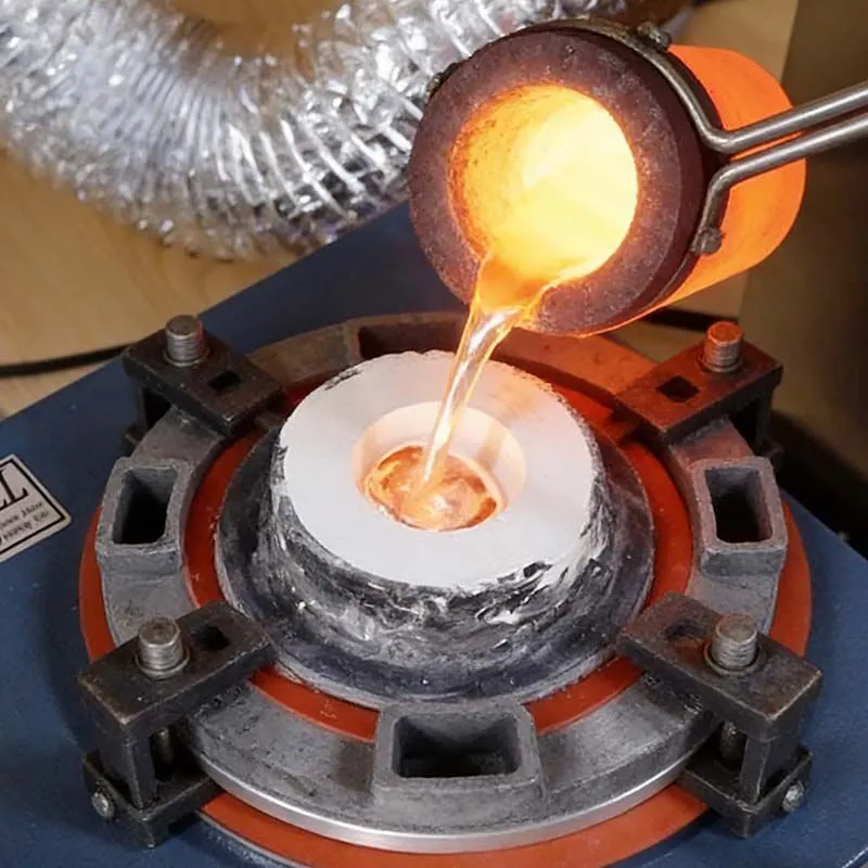 Molten stainless steel being poured into plaster mold during lost wax casting process