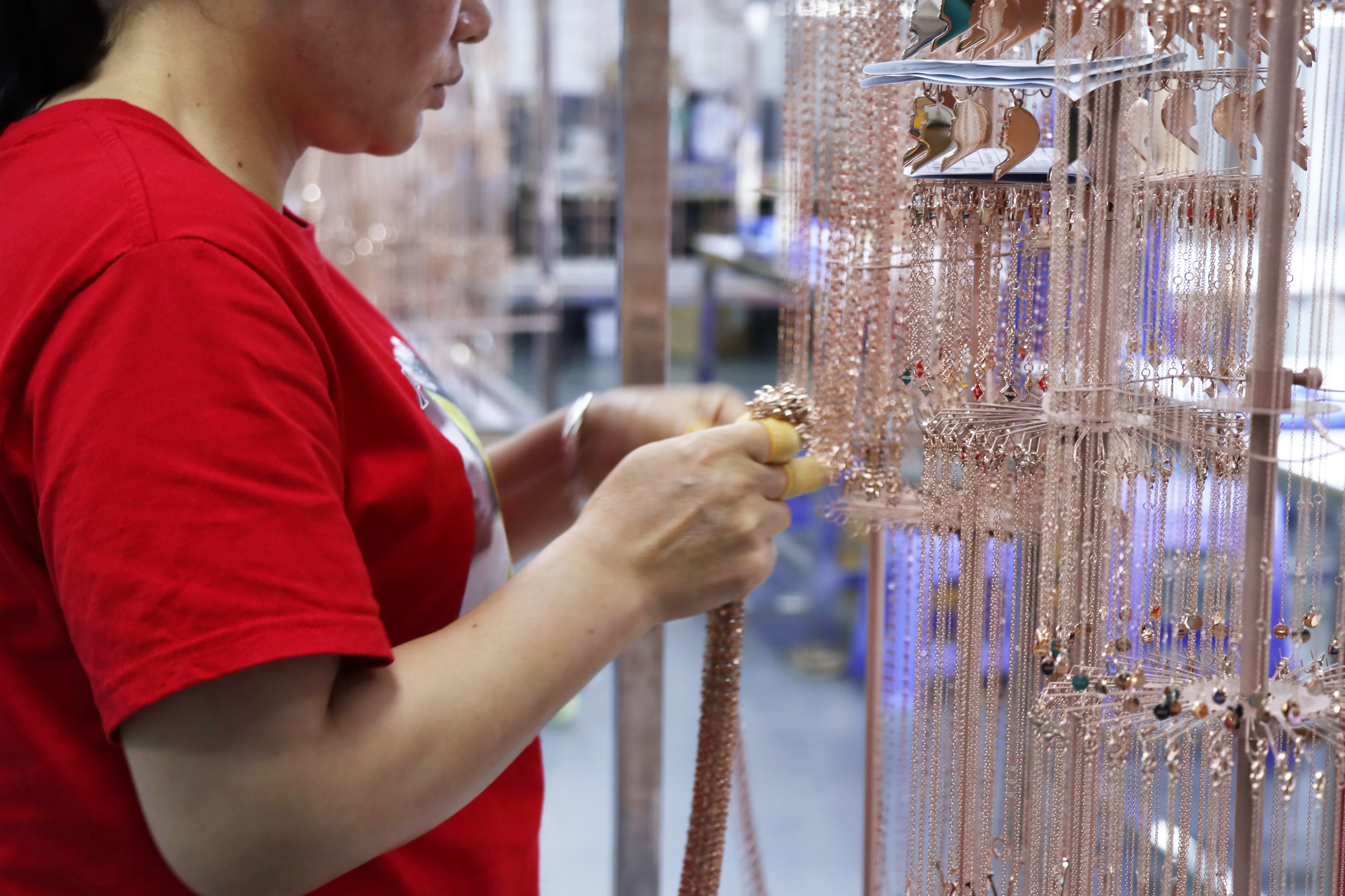 Removing finished PVD plated jewelry from jigs after coating process.