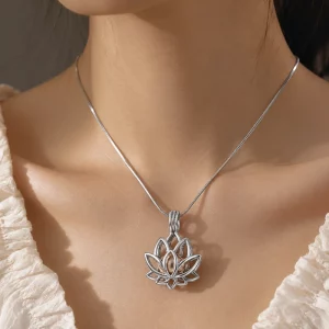 Custom stainless steel locket necklace with a silver lotus design worn by a female model, OEM and ODM jewelry manufacturer for custom brand collections