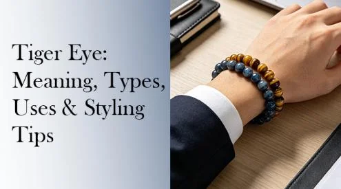 A professional man in a suit wearing a yellow tiger eye and blue tiger eye beaded bracelet stacked next to a laptop.