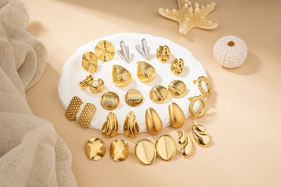 Custom brass earring collection featuring textured hoops, studs, and sculptural statement designs