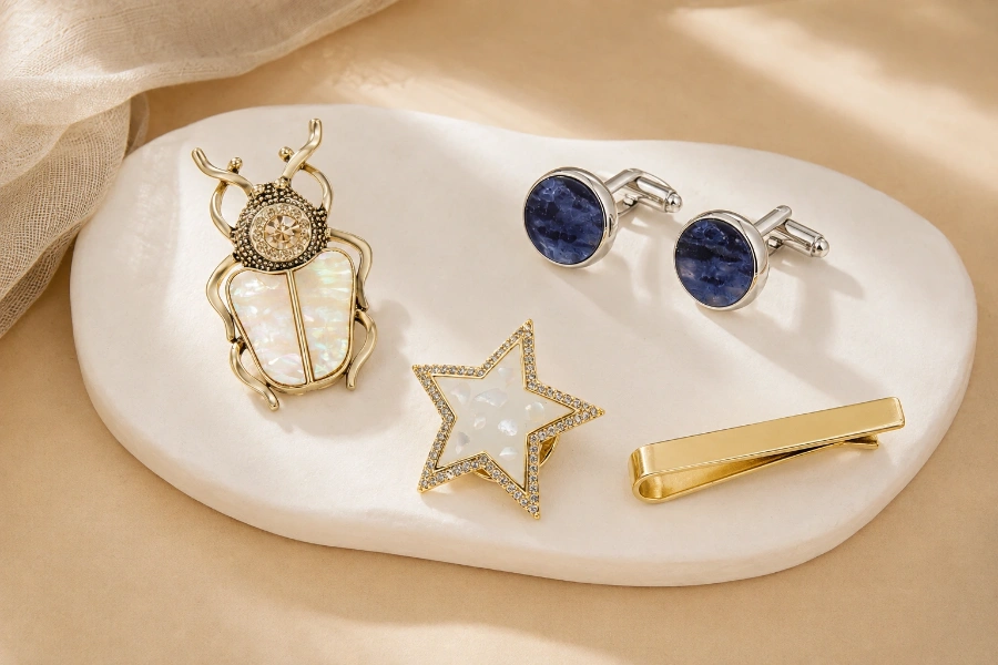 Custom brass jewelry accessories featuring decorative brooches, shell cufflinks, and a gold tie clip