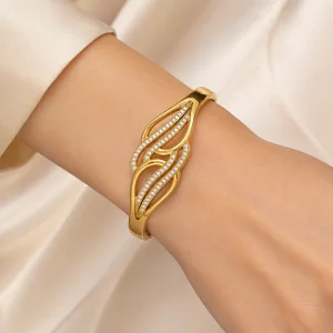 Close-up of a custom stainless steel gold crystal leaf bangle bracelet worn on a model’s wrist for OEM and private label jewelry manufacturing.