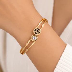 Close-up of a custom gold double-band bangle bracelet with crystal accents worn on a model’s wrist for OEM jewelry brands.
