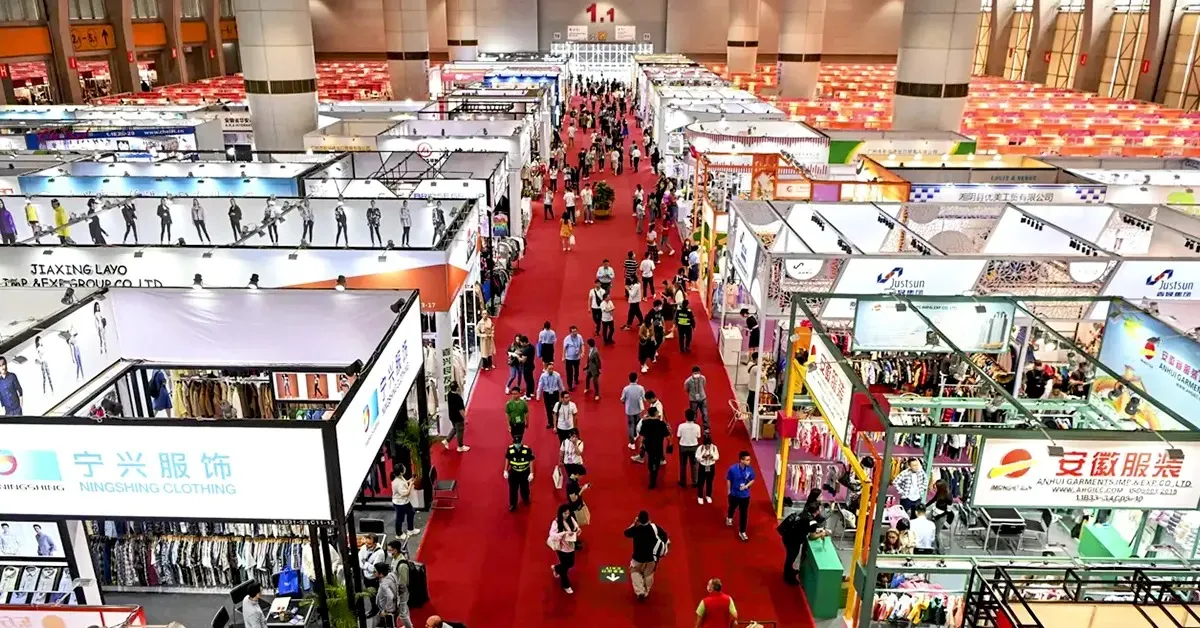 Canton Fair apparel exhibition hall with fashion buyers visiting clothing supplier booths