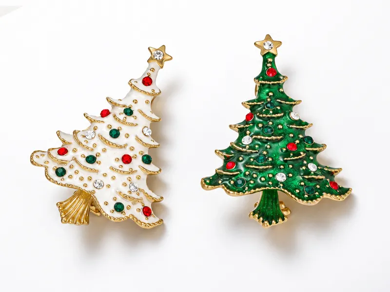 Two coordinated Christmas tree brooch designs illustrating a core-design strategy for custom brooch OEM/ODM manufacturing.