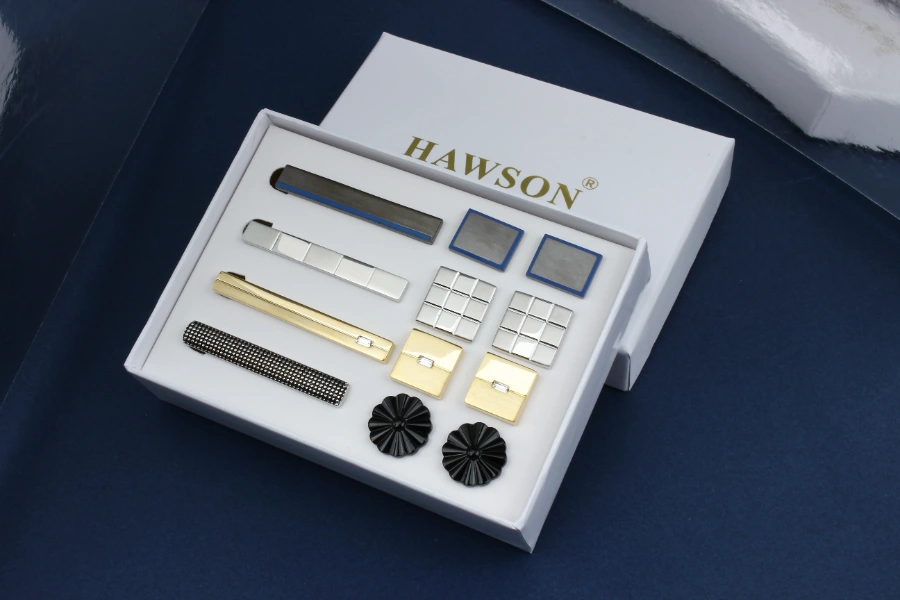 Custom jewelry packaging displaying tie clips and cufflinks in a branded presentation box with a fitted insert for a coordinated accessory collection.