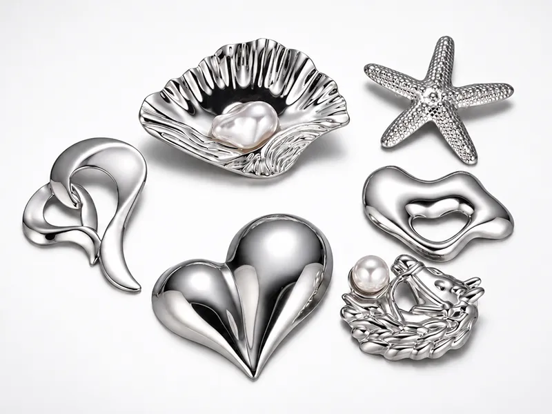 Custom zinc alloy brooch manufacturer showing leaf brooches in silver, gold and rose gold finishes.