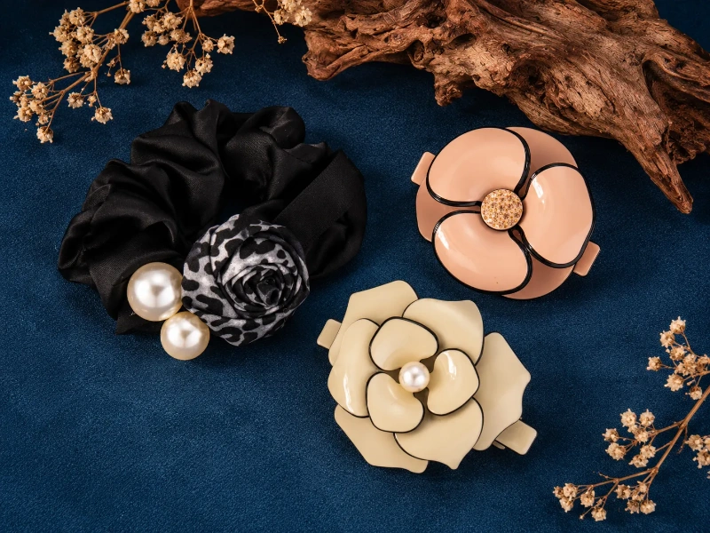 Mixed-material hair accessories combining fabric, pearls, and decorative components for custom designs.