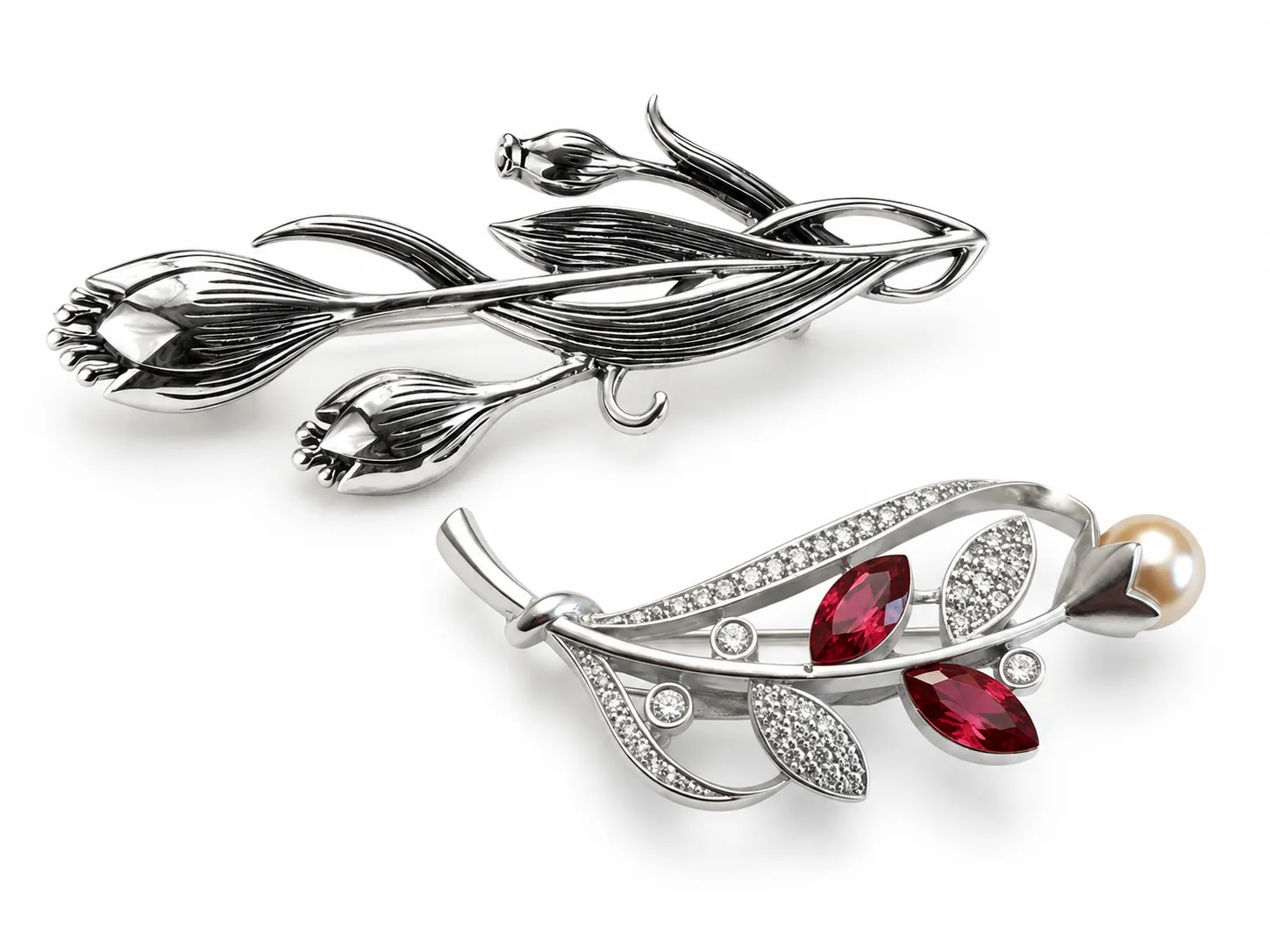 Custom silver brooch designs for fashion jewelry manufacturing, featuring a floral branch brooch and a leaf brooch with red stones and pearl detail.