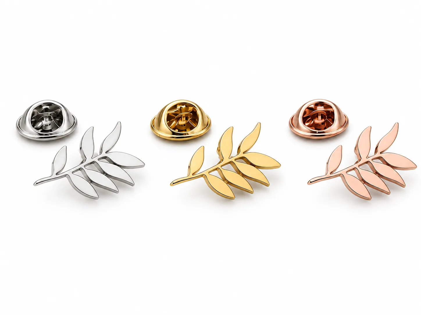 Custom stainless steel leaf brooches in silver, gold and rose gold finishes for fashion jewelry manufacturing.