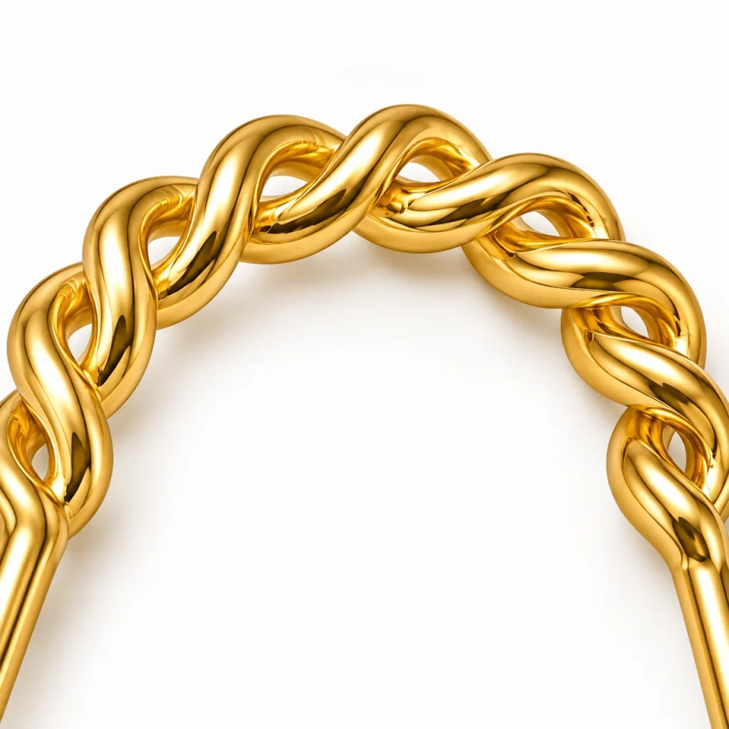 Close-up of the twisted braided top detail and polished 18K gold-plated finish on a U-shaped two-prong hair fork.