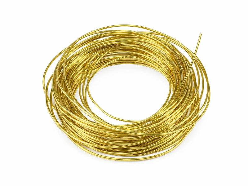 Coiled brass wire with a round cross-section used for making jewelry components such as jump rings, chain links, hoop earrings, and decorative wire loops.