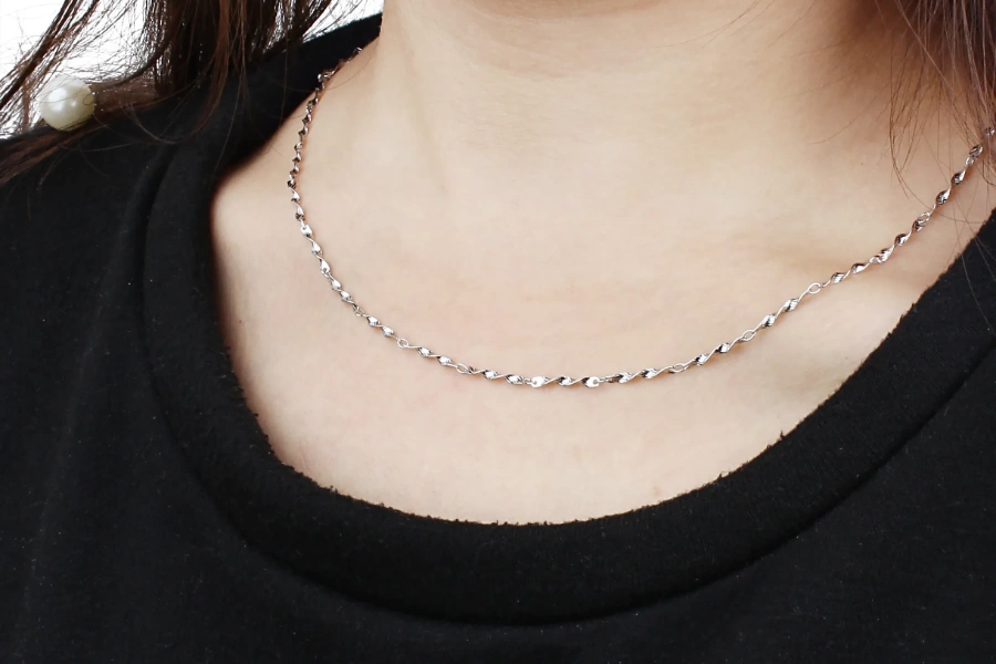 Custom stainless steel chain necklaces styled with clothing collections for fashion brands