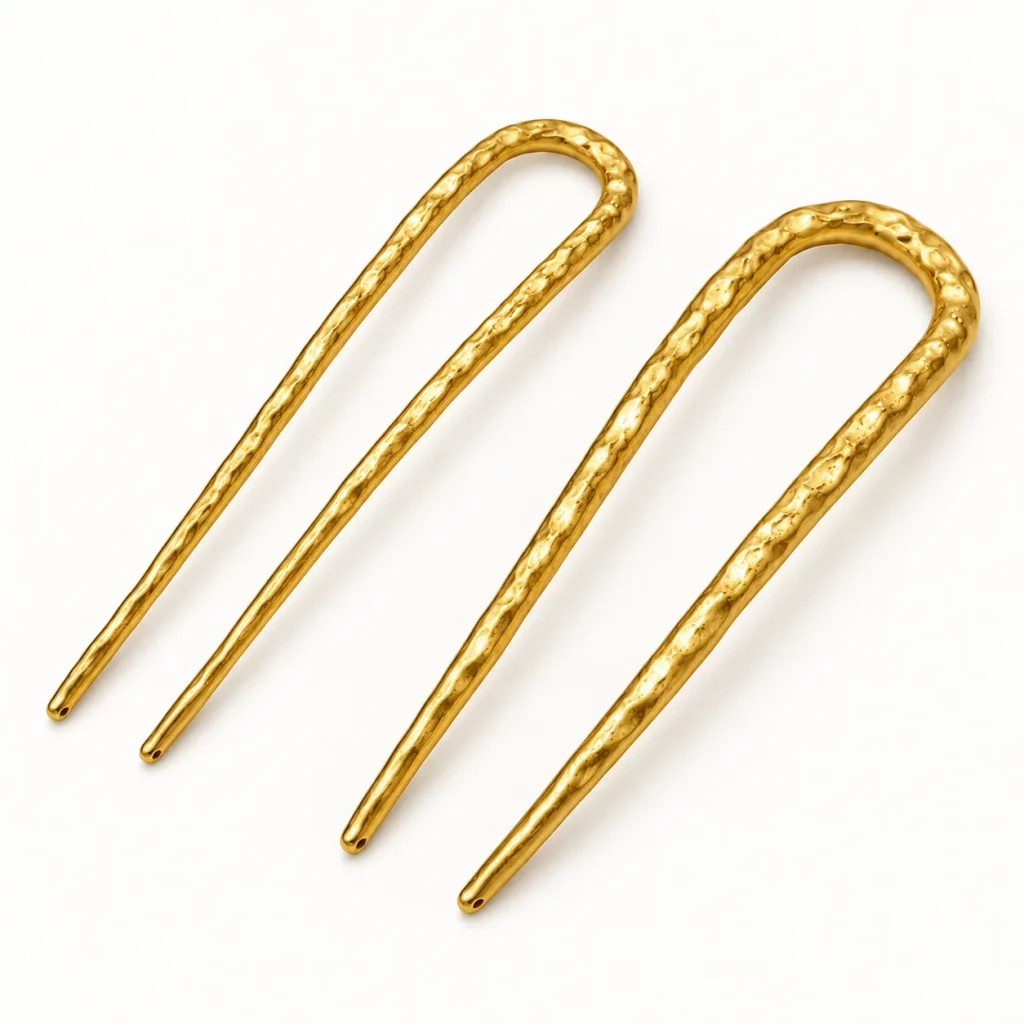 Two hammered gold-tone U-shaped hair forks showing different prong spacing and overall proportions for custom design selection.