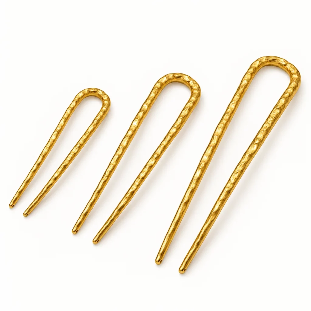 Three hammered gold-tone U-shaped two-prong hair forks in different sizes for custom length and proportion selection.