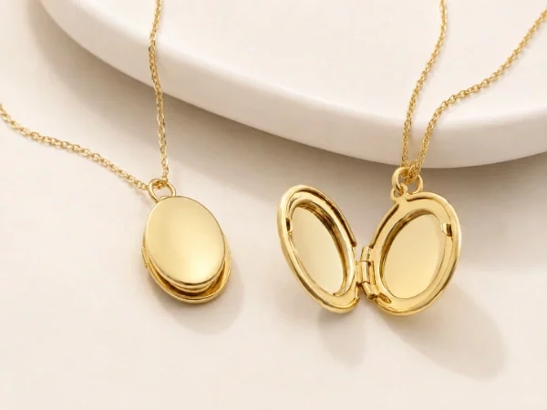 Custom oval stainless steel locket necklace shown in open and closed styles with polished gold PVD finish